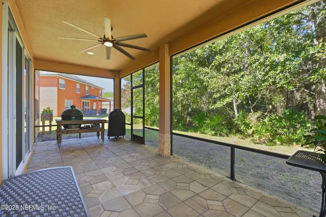 a view of a porch with chairs and backyard