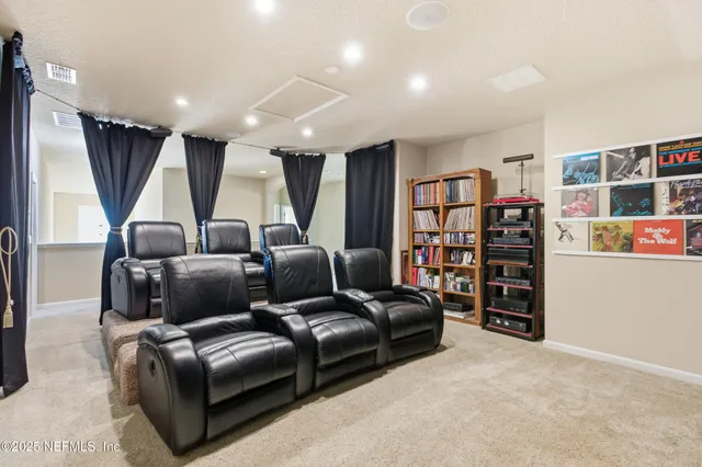 a living room with furniture a cabinet and a book shelf