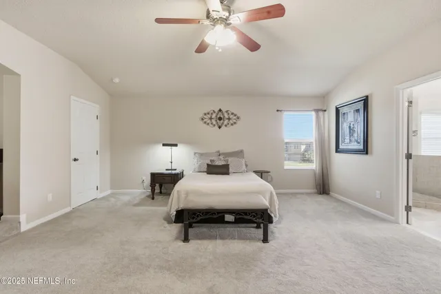 a spacious bedroom with a bed and window