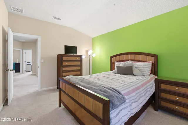 a bedroom with a bed and a television