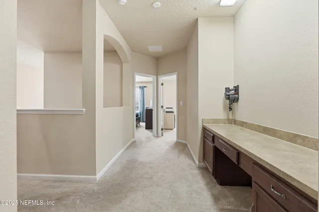 a spacious bathroom with a granite countertop sink and a mirror