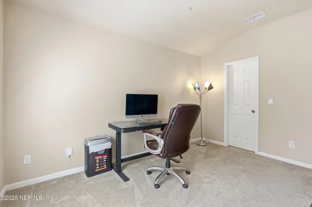 a view of a workspace with furniture
