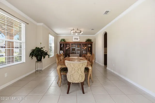 a view of a dining room with furniture and chandelier