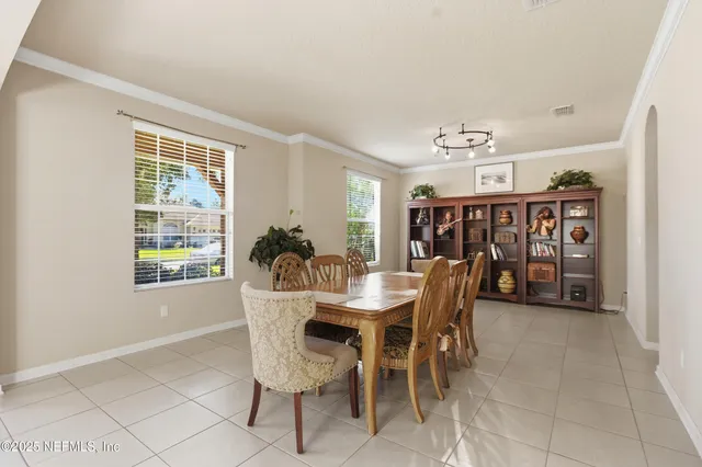 a dining room with furniture and window