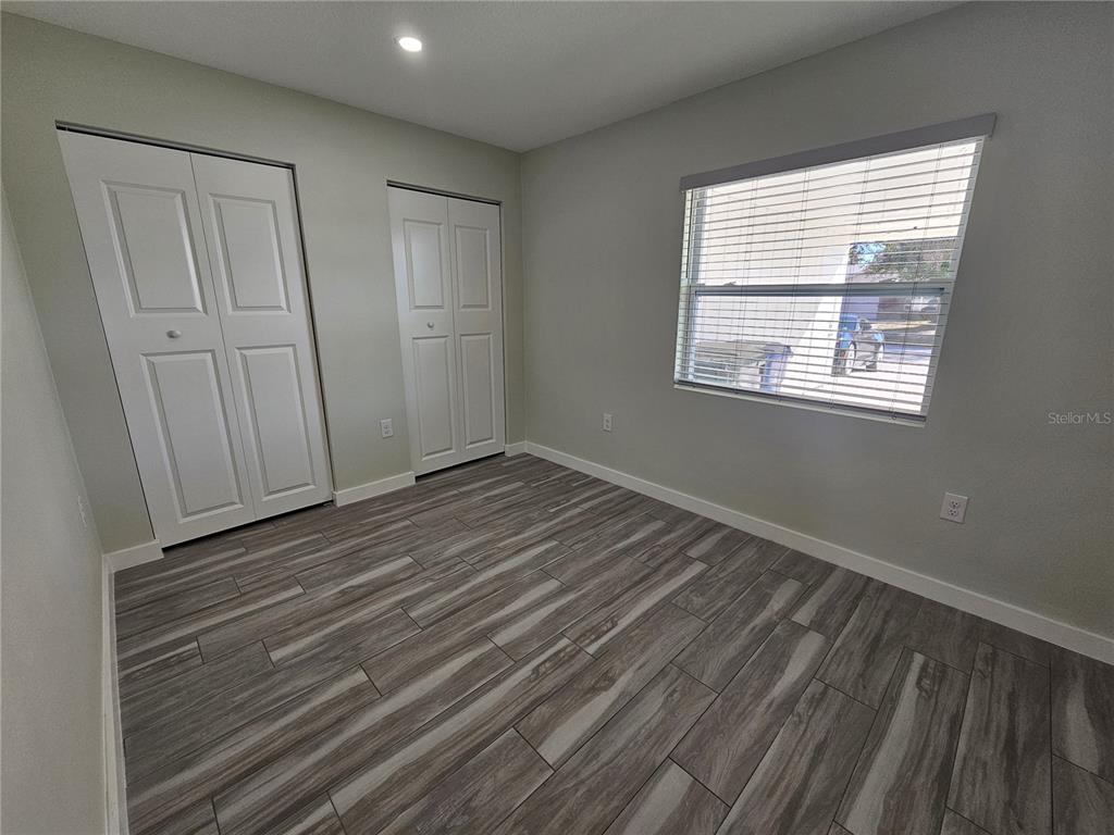 7043 Brentford Road Sarasota, FL 34241 - Photo 13 of 19 a view of a room with wooden floor and window
