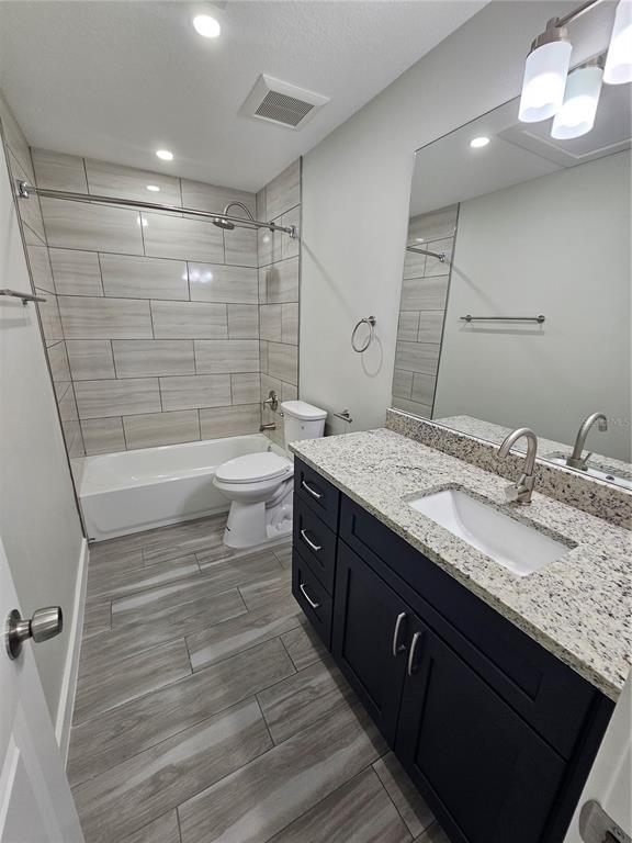 7043 Brentford Road Sarasota, FL 34241 - Photo 15 of 19 a bathroom with a granite countertop sink toilet and shower