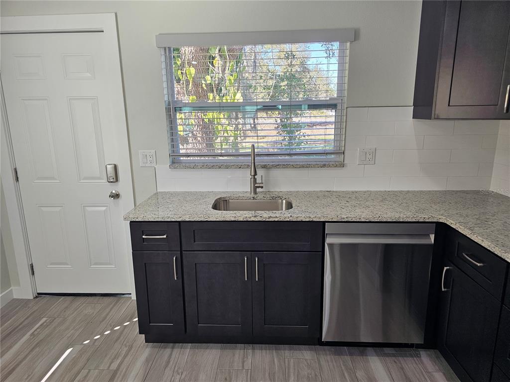 7043 Brentford Road Sarasota, FL 34241 - Photo 6 of 19 a kitchen with a sink and wooden cabinets