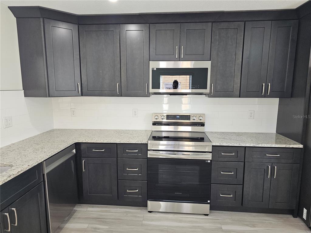 7043 Brentford Road Sarasota, FL 34241 - Photo 7 of 19 a kitchen with a stove and a cabinets