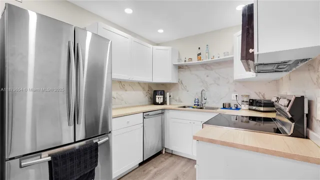 a kitchen with appliances cabinets and a sink