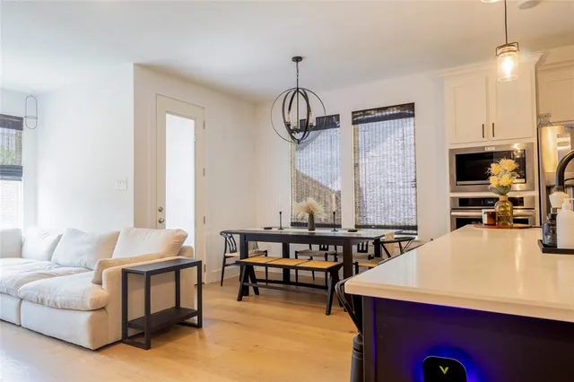 a living room with fireplace furniture and a chandelier