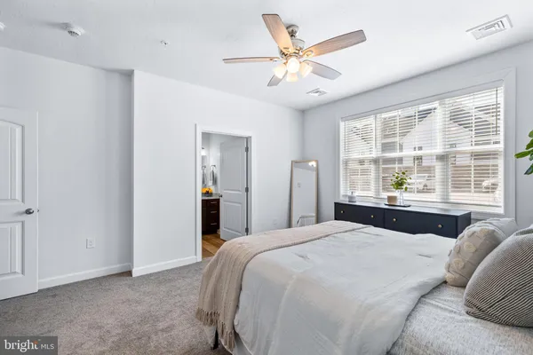a bedroom with a large bed and a large window