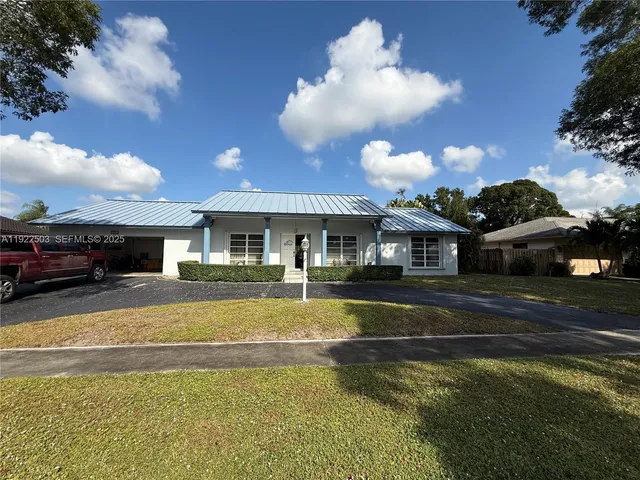 a view of a house with swimming pool and a yard