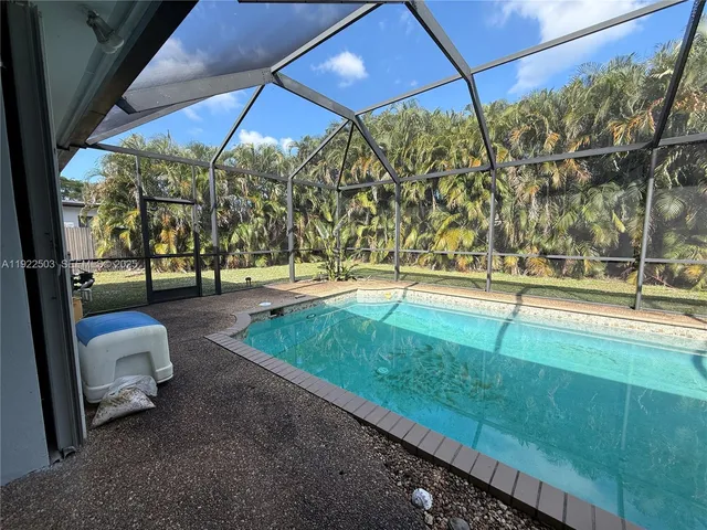 a view of a swimming pool with a patio