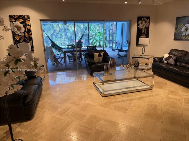 a living room with fireplace furniture and a large window
