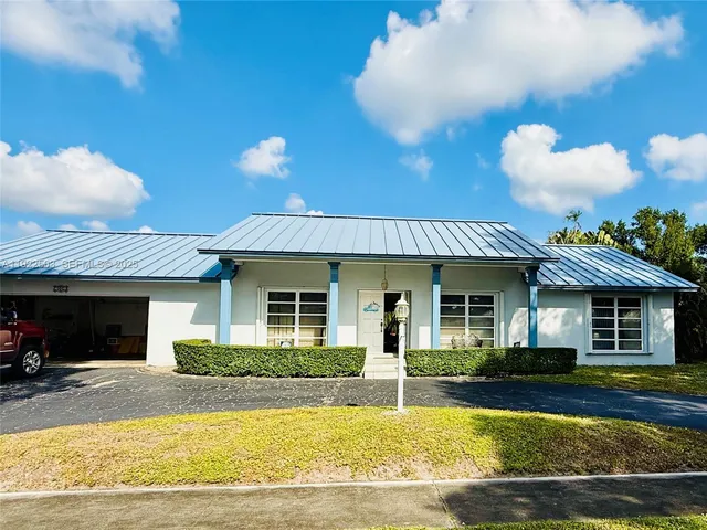 a view of a house with swimming pool and a yard