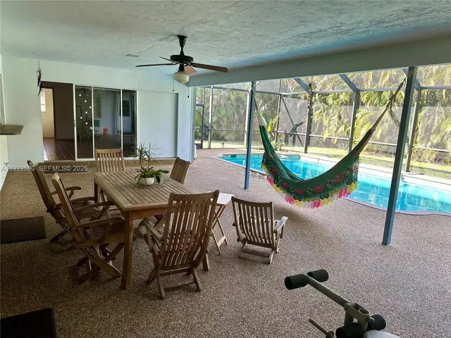 a view of a dining room with furniture window and outside view