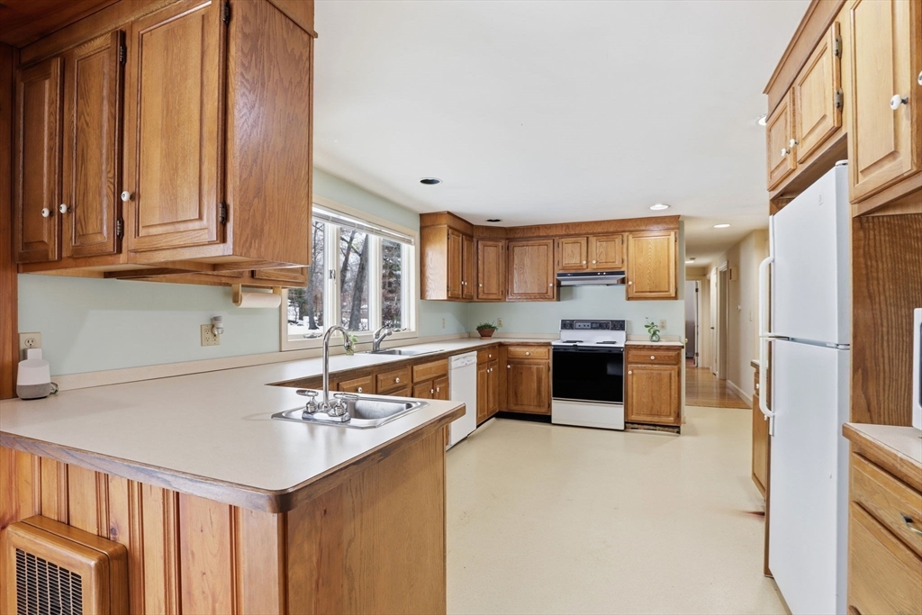 49 Jackson Road Scituate, MA 02066 - Photo 6 of 25 a kitchen with a refrigerator a sink and a stove