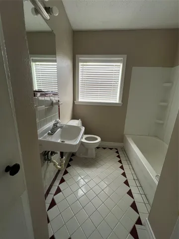 a bathroom with a sink a toilet and tub