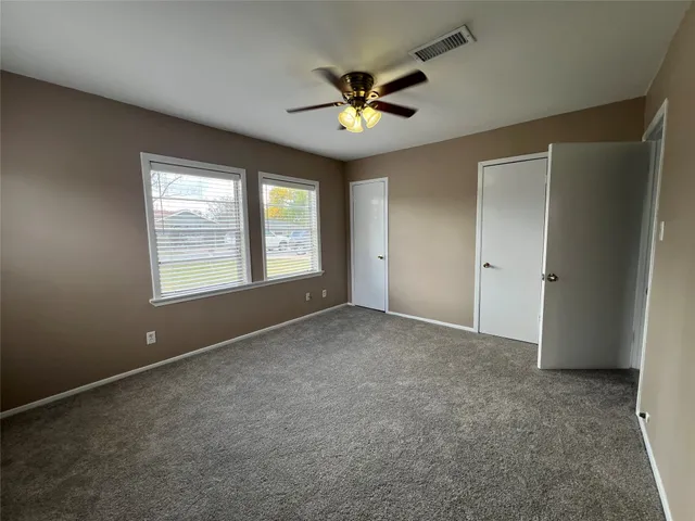 a view of a livingroom with a ceiling fan and window