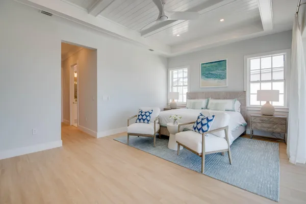 a bedroom with bed couch and window