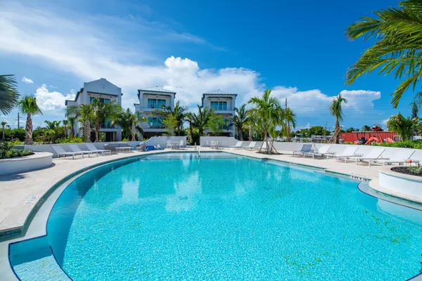 a swimming pool with outdoor seating and yard