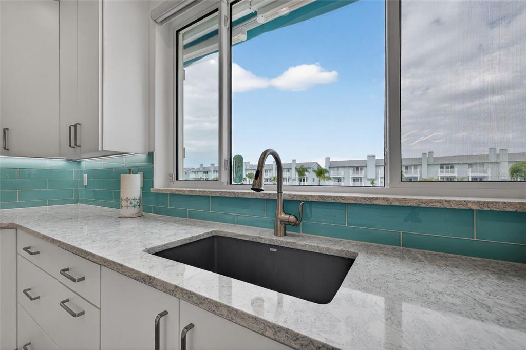 314 6th Avenue Indian Rocks Beach, FL 33785 - Photo 16 of 60 a kitchen with a sink and a large window