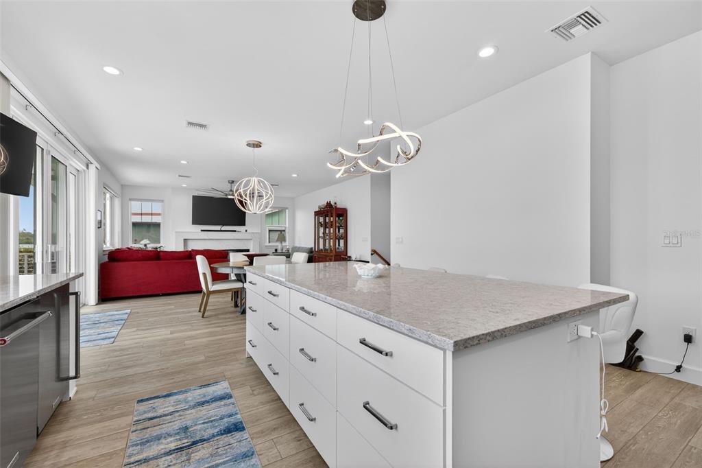 314 6th Avenue Indian Rocks Beach, FL 33785 - Photo 18 of 60 a kitchen with kitchen island granite countertop a sink cabinets and wooden floor