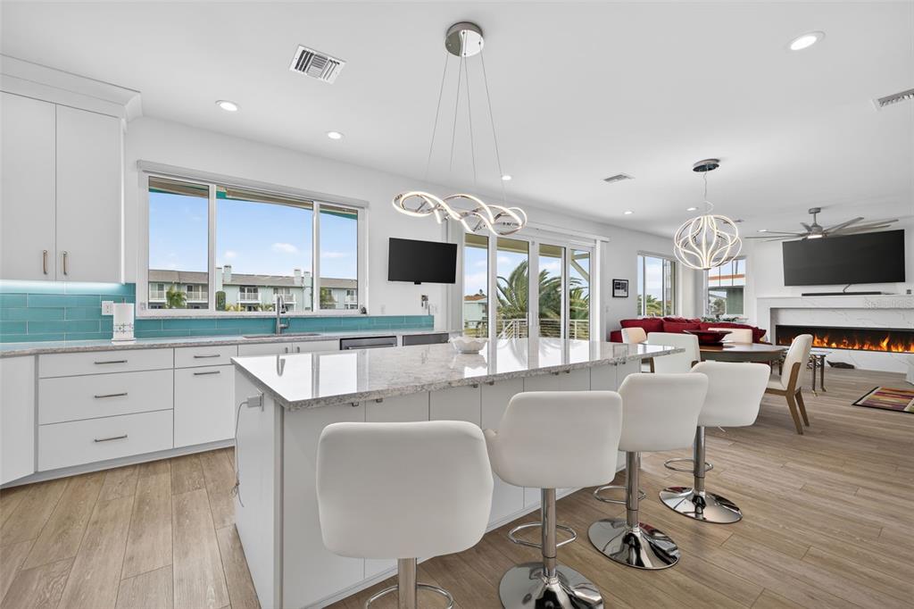 314 6th Avenue Indian Rocks Beach, FL 33785 - Photo 20 of 60 a living room with furniture a flat screen tv and kitchen view