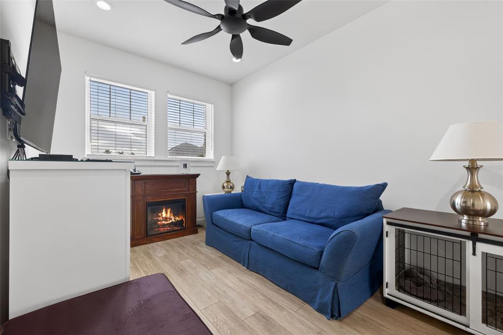 314 6th Avenue Indian Rocks Beach, FL 33785 - Photo 24 of 60 a living room with furniture a fireplace and a flat screen tv