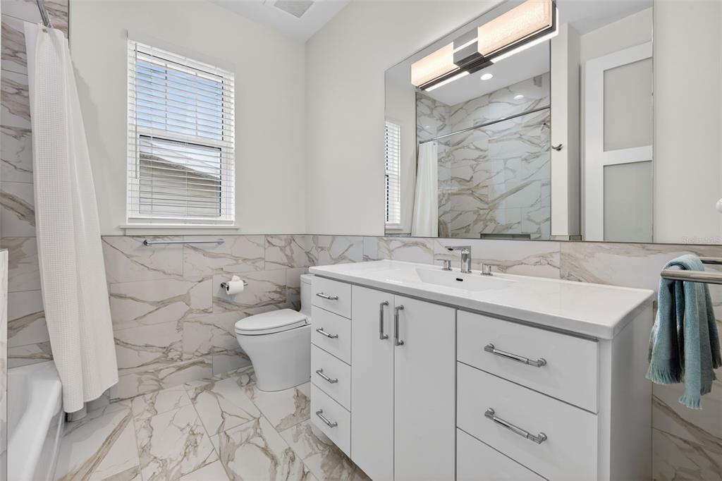 314 6th Avenue Indian Rocks Beach, FL 33785 - Photo 26 of 60 a bathroom with a double vanity sink and a toilet