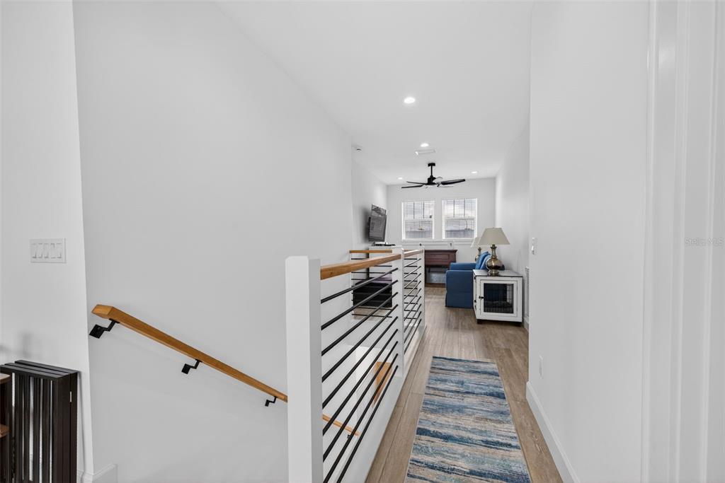 314 6th Avenue Indian Rocks Beach, FL 33785 - Photo 34 of 60 a hallway with a white stove top oven and chairs