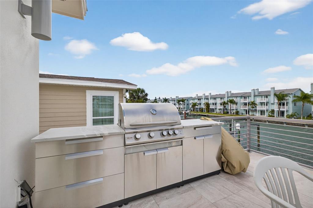 314 6th Avenue Indian Rocks Beach, FL 33785 - Photo 35 of 60 a kitchen with a stove cabinets and flowerpot