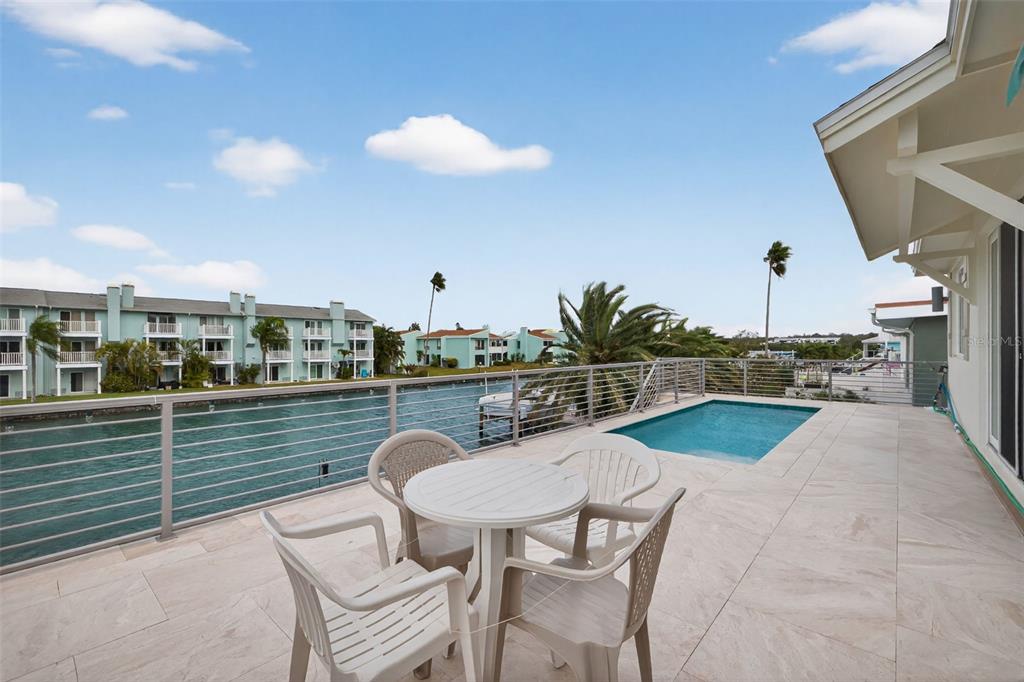 314 6th Avenue Indian Rocks Beach, FL 33785 - Photo 36 of 60 a balcony with table and chairs