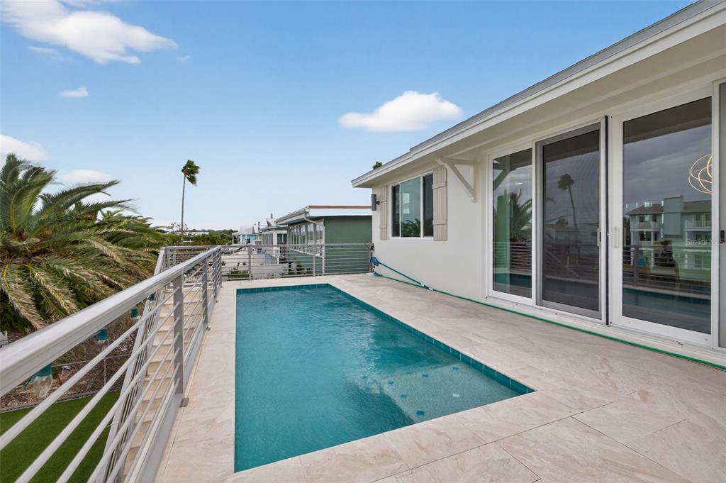 314 6th Avenue Indian Rocks Beach, FL 33785 - Photo 38 of 60 a view of a balcony with two chairs