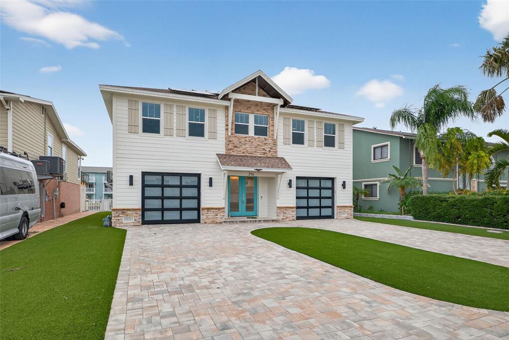 314 6th Avenue Indian Rocks Beach, FL 33785 - Photo 4 of 60 a view of a house with a yard and garage