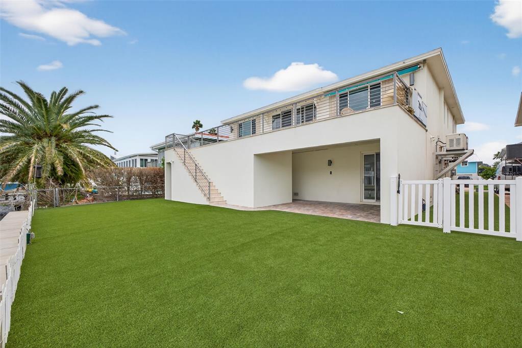 314 6th Avenue Indian Rocks Beach, FL 33785 - Photo 46 of 60 a view of a house with a yard and garage