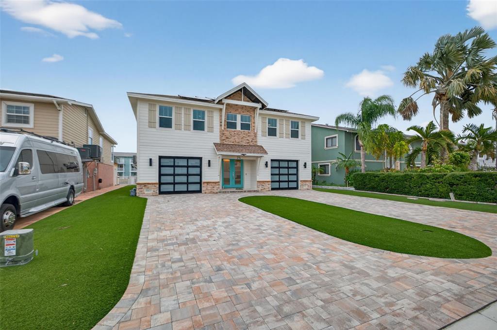 314 6th Avenue Indian Rocks Beach, FL 33785 - Photo 5 of 60 a front view of a house with a yard and garage