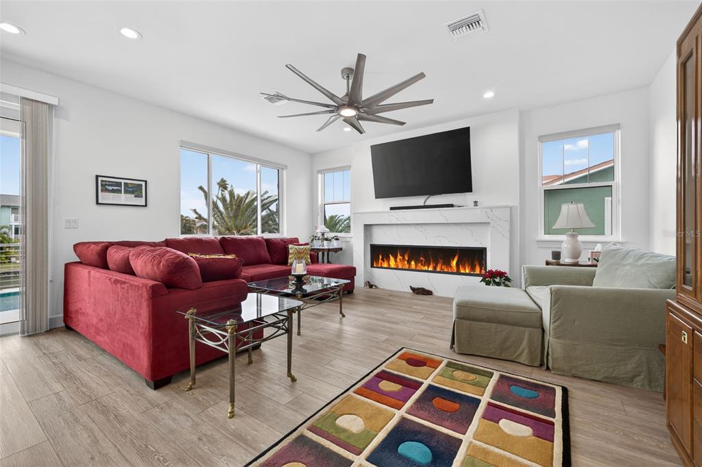 314 6th Avenue Indian Rocks Beach, FL 33785 - Photo 9 of 60 a living room with furniture a flat screen tv and a fireplace