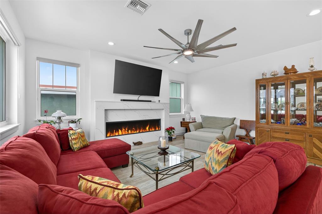 314 6th Avenue Indian Rocks Beach, FL 33785 - Photo 10 of 60 a living room with furniture a fireplace and a flat screen tv