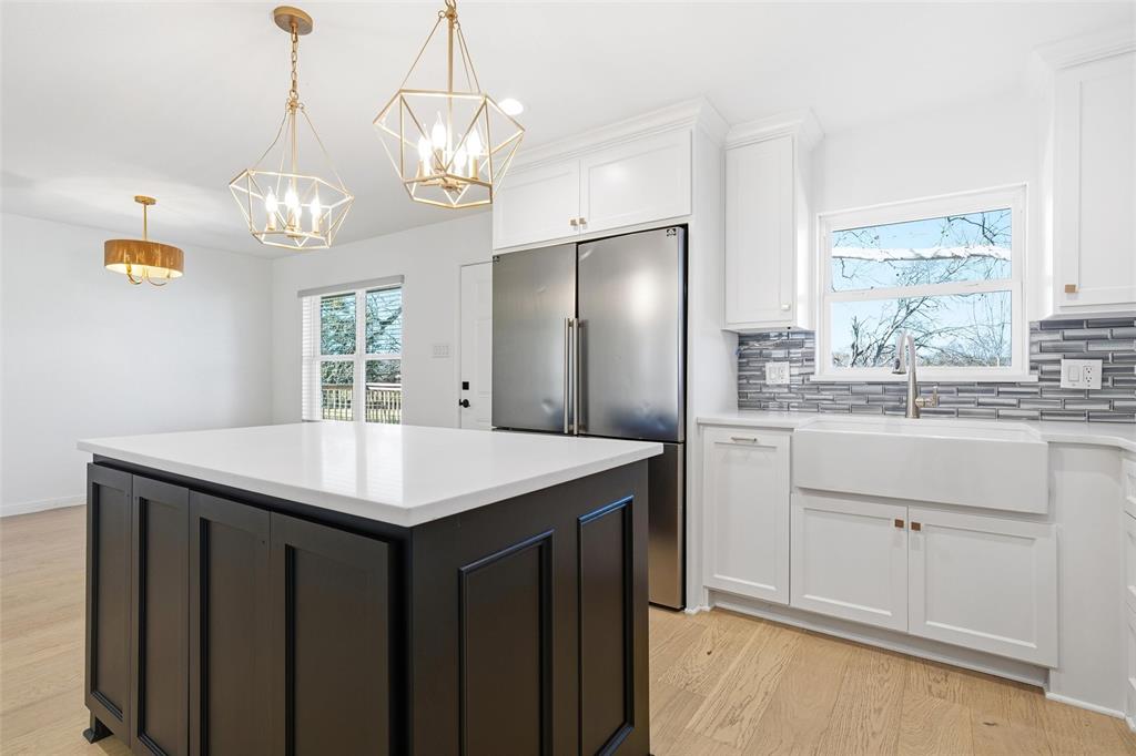 301 West Tinsley Road Robinson, TX 76706 - Photo 12 of 40 a kitchen with a sink a center island and a window
