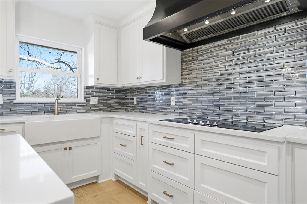 301 West Tinsley Road Robinson, TX 76706 - Photo 14 of 40 a kitchen with white cabinets and sink