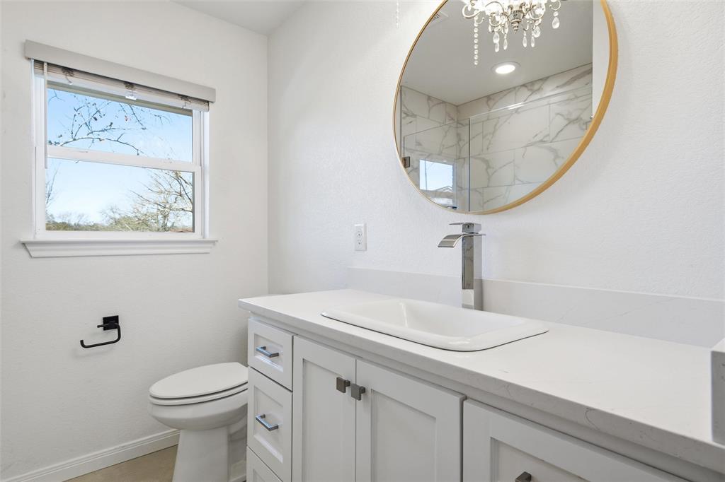 301 West Tinsley Road Robinson, TX 76706 - Photo 20 of 40 a bathroom with a toilet a sink and mirror
