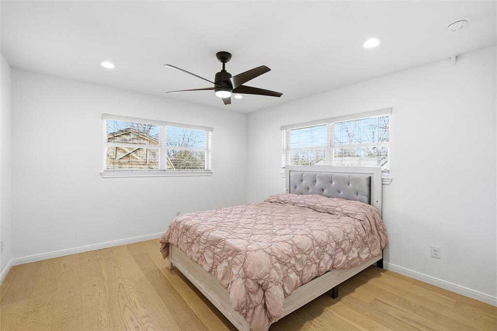 301 West Tinsley Road Robinson, TX 76706 - Photo 24 of 40 a bedroom with a large bed and a chandelier