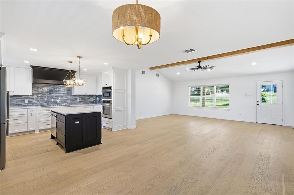 301 West Tinsley Road Robinson, TX 76706 - Photo 8 of 40 a large kitchen with kitchen island granite countertop a sink stainless steel appliances and cabinets