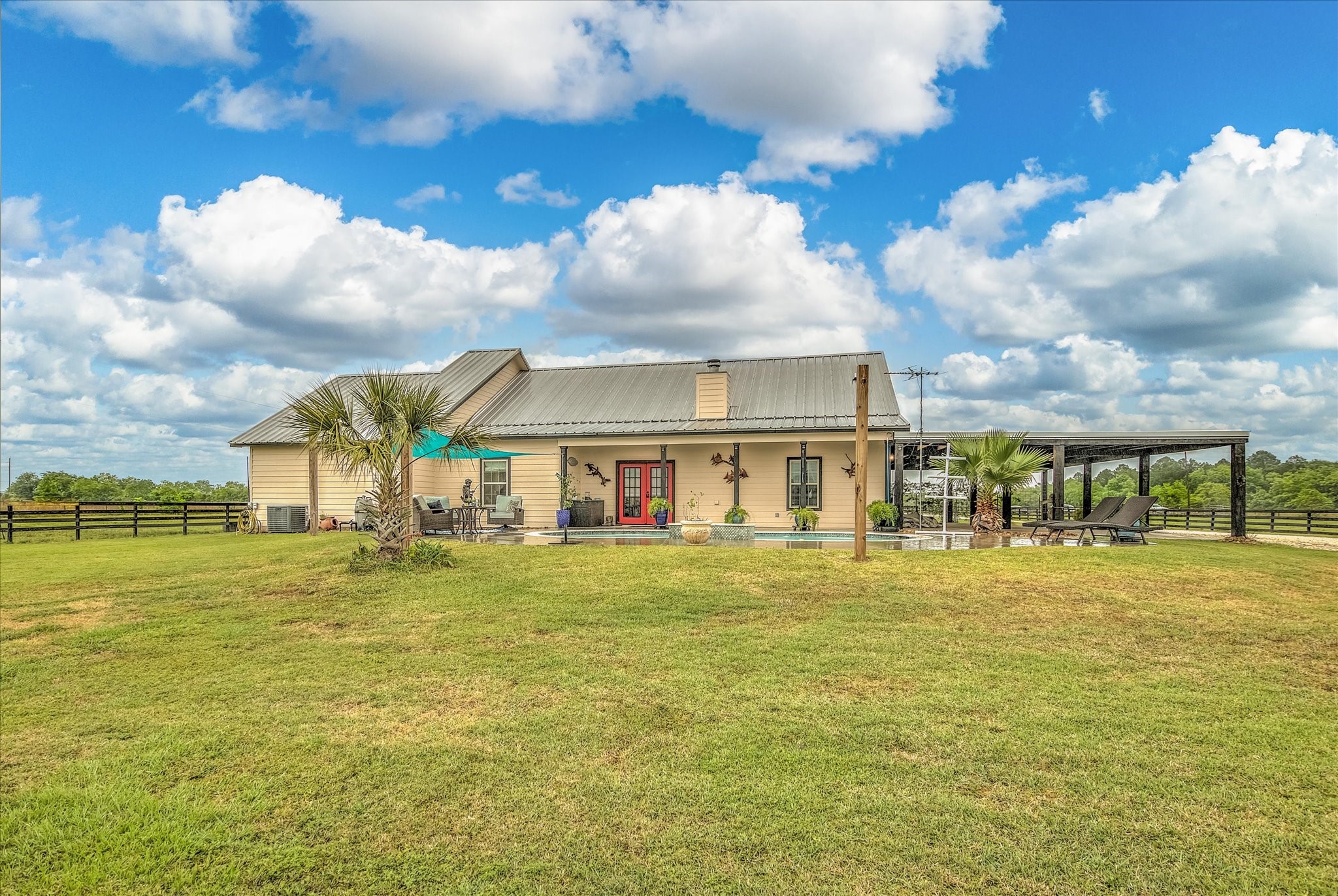 1755 McBride-Devillier Loop Winnie, TX 77665 - Photo 30 of 44 a view of a big house with a big yard and large trees
