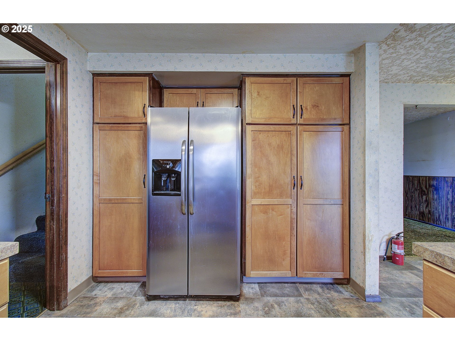 19409 Northeast Mattson Road Brush Prairie, WA 98606 - Photo 12 of 44 an empty room with wooden floor cabinet and refrigerator