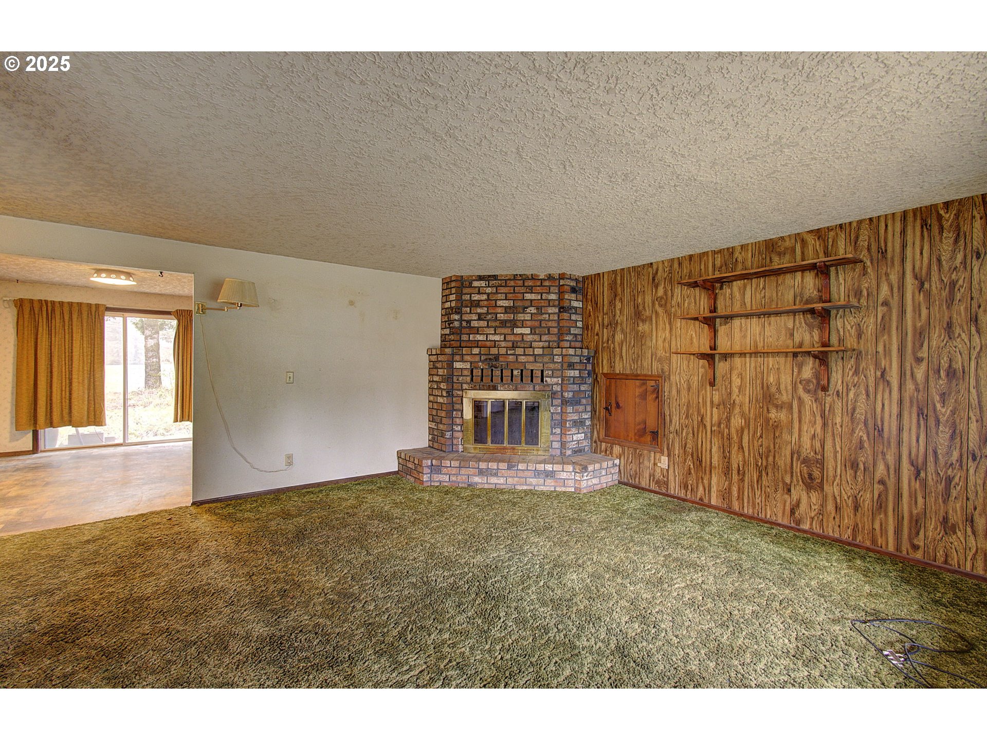 19409 Northeast Mattson Road Brush Prairie, WA 98606 - Photo 7 of 44 a view of an empty room with wooden floor and a window