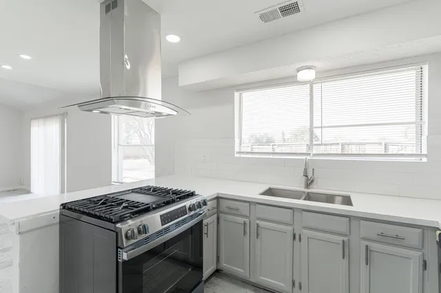 a kitchen with a stove and a sink