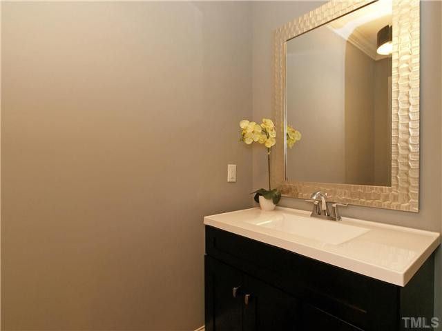 2101 Morrocroft Drive Raleigh, NC 27615 - Photo 21 of 22 This Powder Room Has A Stunning Designer Mirror, Unique Furniture Piece Vanity And A Designer Light Fixture. Half Bath