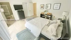 a bedroom with a bed and flat screen tv